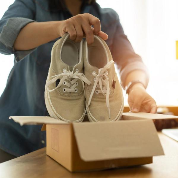 Person putting shoes into a box