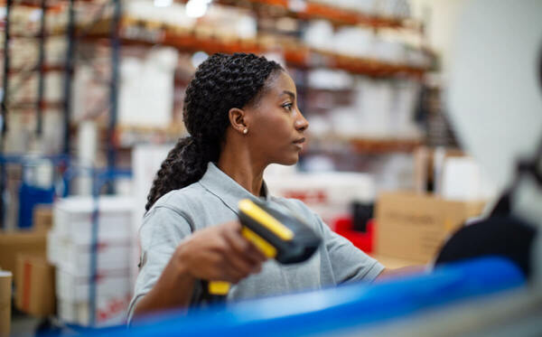 woman in warehouse holding scanner