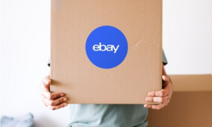 Person holding a box with the eBay logo