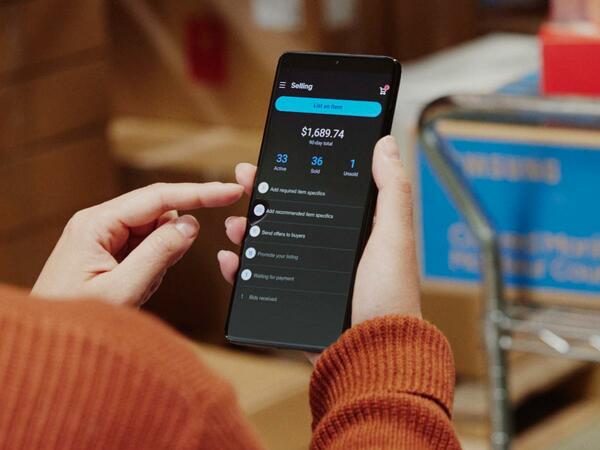A person viewing their eBay account balance on a phone.