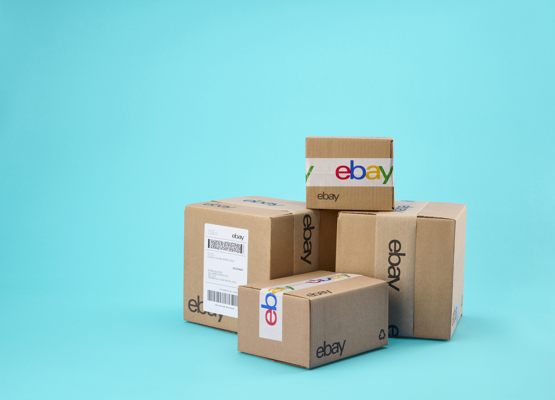 pile of boxes with eBay packaging against a blue background