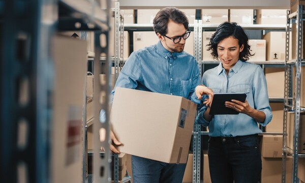 man and woman packing in warehouse