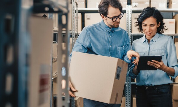 man and woman in warehouse with packages