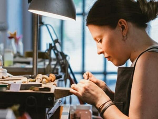 A jeweler working at her desk.