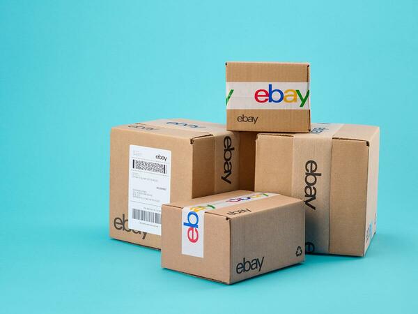 a pile of eBay packages with skyblue background