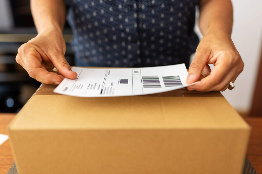 man putting label on box