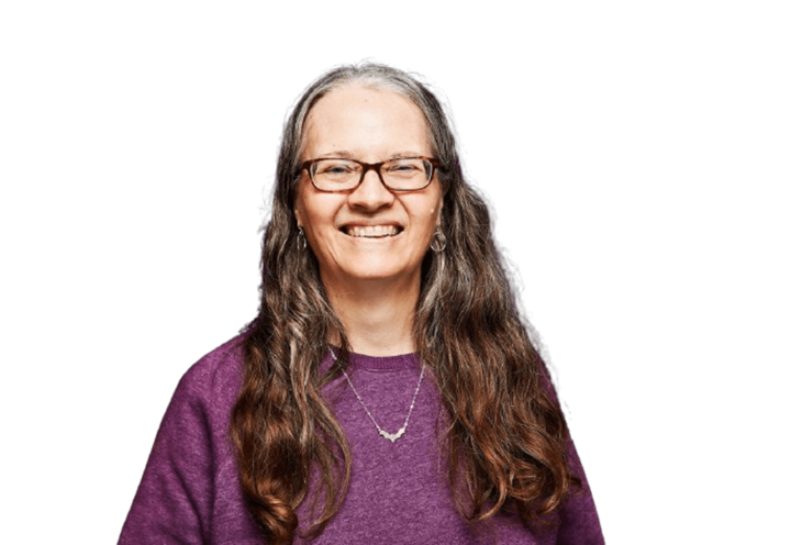 Woman wearing purple shirt and smiling.