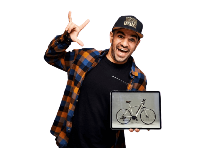A person smiling excitedly at the camera, holding a picture of a bicycle