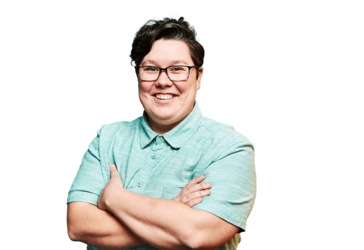 Woman with crossed arms wearing a blue golf shirt and glasses.