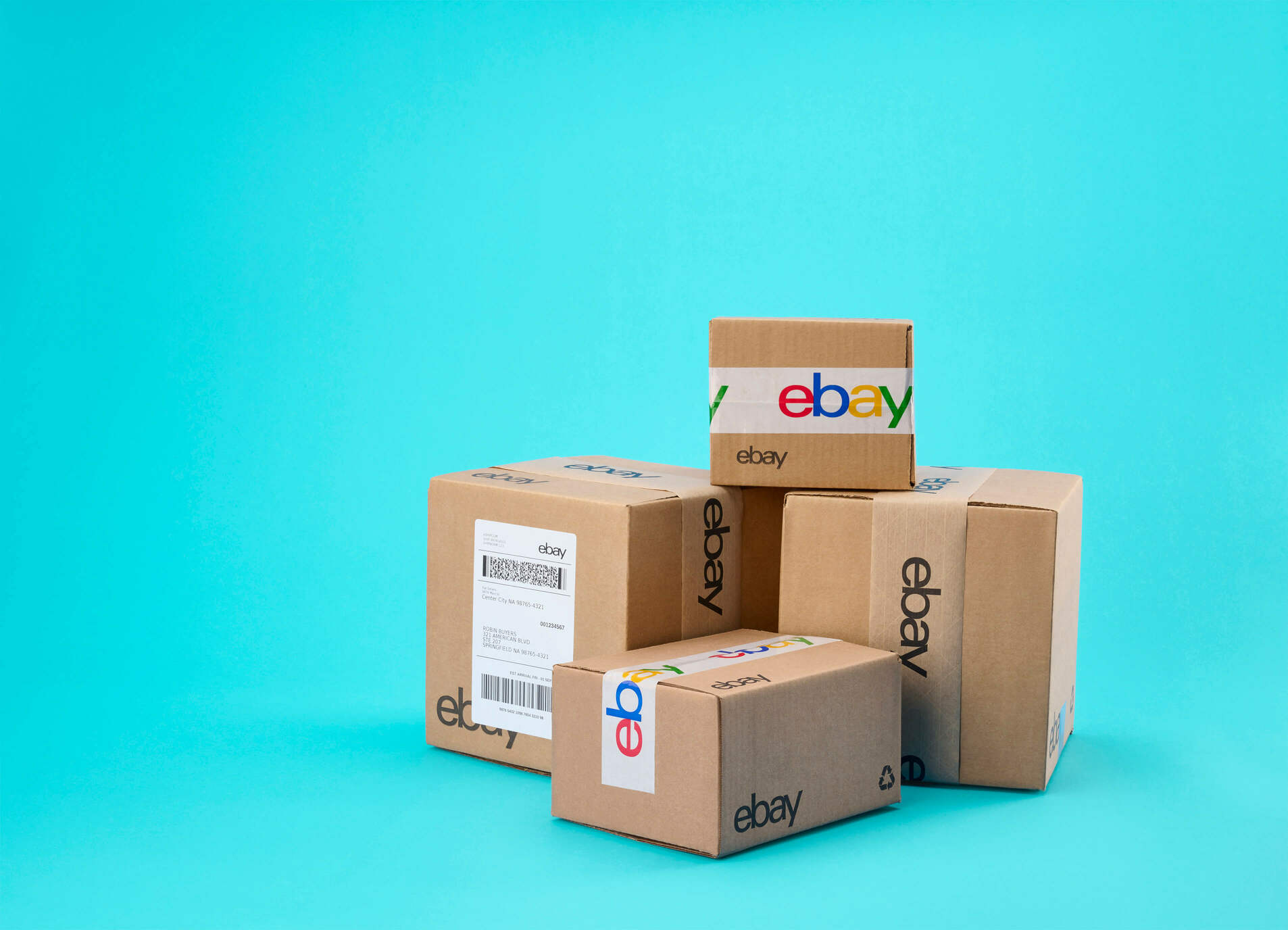 pile of boxes with eBay packaging against a blue background