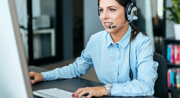 Employee at the computer with headset on