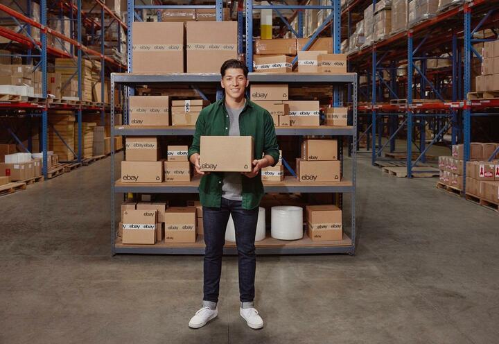 Man in warehouse holding parcel