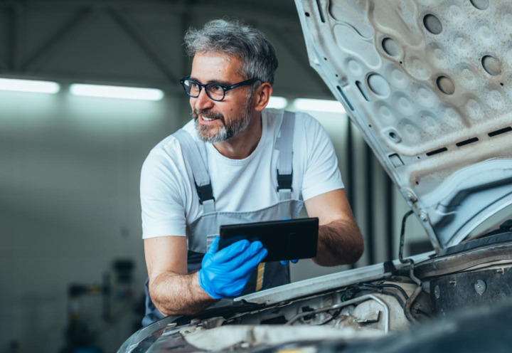 man under hood of car